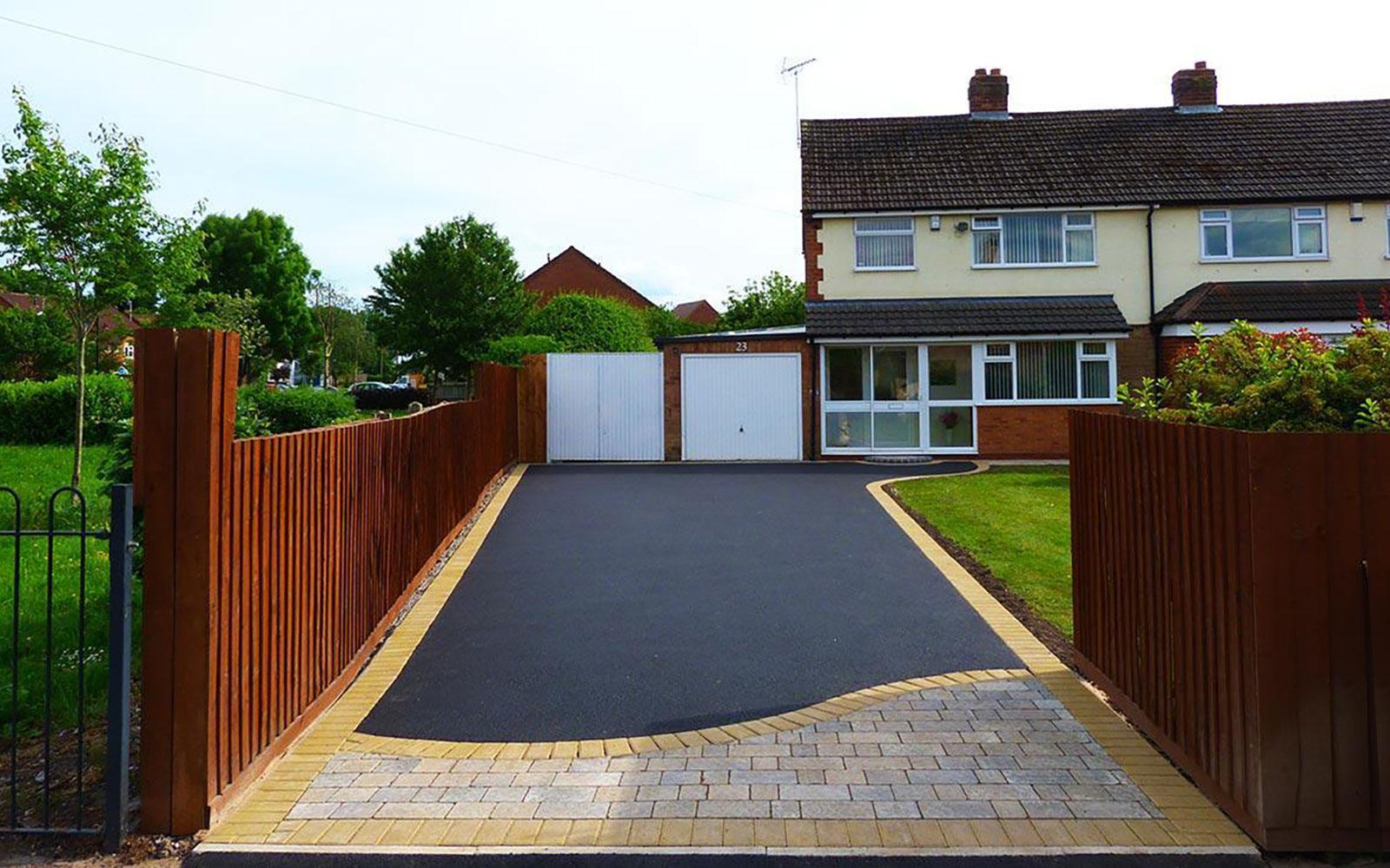 Long tarmac driveway with a contrasting yellow block border